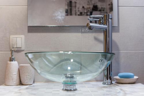 a glass bowl sink on a counter in a bathroom at Red Rose Apartment in Portorož