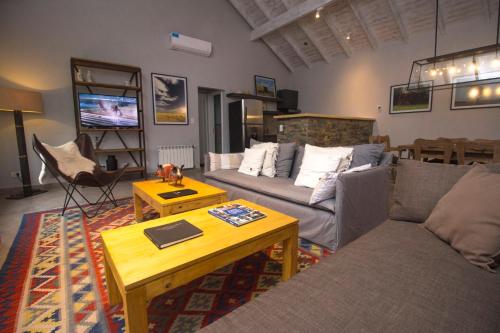 a living room with a couch and a table at Hostería & Spa De La Cascada in Tandil