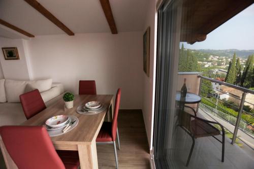a room with a table and chairs and a balcony at Red Rose Apartment in Portorož