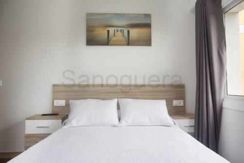 a bedroom with a white bed and a window at Pensión CHE in O Pedrouzo