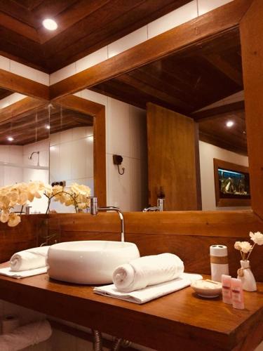 a bathroom counter with a sink and a mirror at Aldeia do Bambu Camping e Chalés in Quartéis