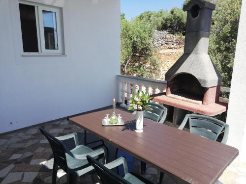 a patio with a table and an outdoor oven at Villa Frane 101 in Beli