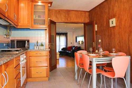 a kitchen with a table and chairs in a kitchen at Apartamento RH in Nazaré