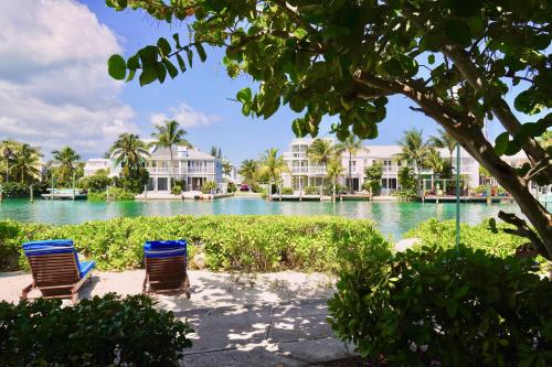 two chairs sitting in front of a body of water at Sandyport Beach Resort in Nassau