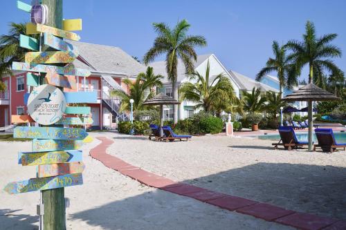 a sign on the beach next to a resort at Sandyport Beach Resort in Nassau