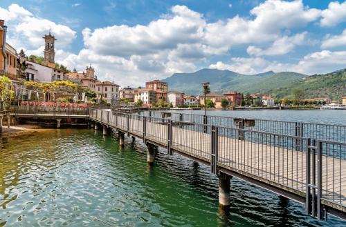 a bridge over a body of water with buildings at Villa Rina Deluxe and Cottage in Porto Ceresio