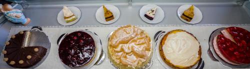 a bunch of different types of breads and pies at Café und Pension Theodor Fontane in Altenbrak