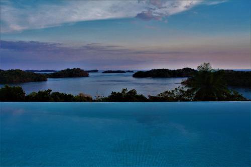an island in the middle of a large body of water at Boca Chica Bay Eco Lodge in Boca Chica