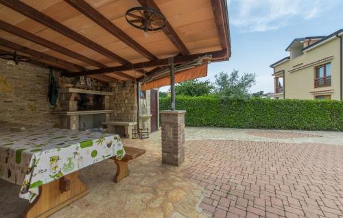 a patio with a wooden pergola and a table at Apartments Hana in Funtana in Funtana