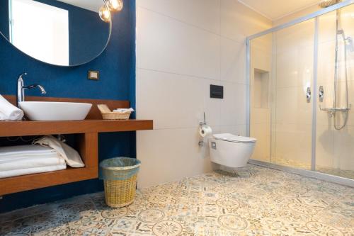 a bathroom with a toilet and a sink and a shower at Hotel Karbel Sun in Oludeniz