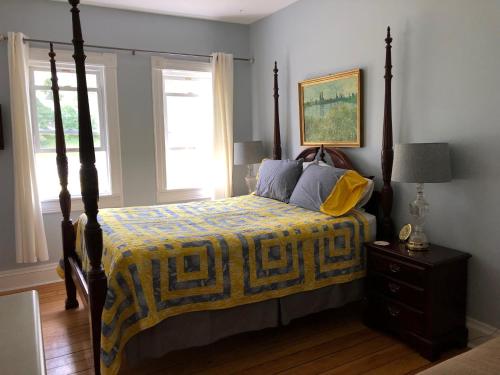 a bedroom with a bed with a yellow and blue blanket at Lucy's Place in Bayfield