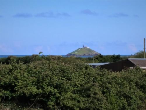 a cross on top of a hill with trees at shanagarry / Ballycotton Glamping pod in Cork
