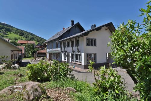a white house with a black roof at Locations des 3 sommets avec Sauna et Spa en Alsace in Sondernach