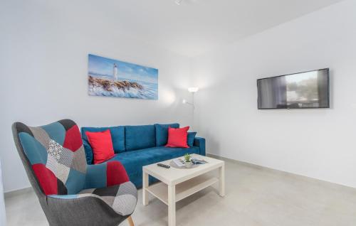a living room with a blue couch and a table at Apartments Hana in Funtana in Funtana