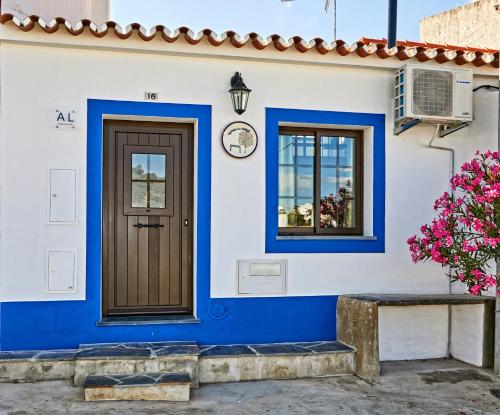 a blue and white house with a door and windows at Recanto do Telheiro in Monsaraz