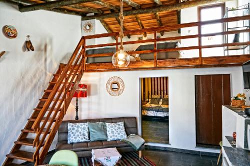 a living room with a staircase and a couch at Recanto do Telheiro in Monsaraz