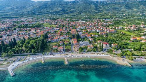 an aerial view of a town on a beach at Apartments Meštrović with heated swiming pool- near Split in Kaštela