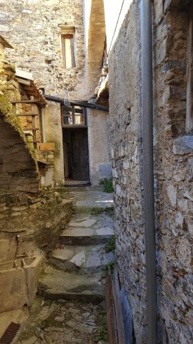 an alley in an old building with a stone wall at Agriturismo Nonnamelia in Nasino