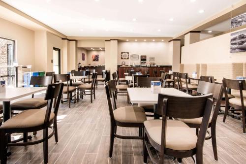 a dining room filled with tables and chairs at Sleep Inn & Suites Moab near Arches National Park in Moab