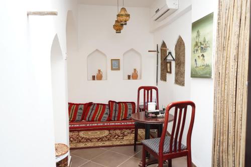 a living room with a couch and a table at Date Palm Inn in Nizwa