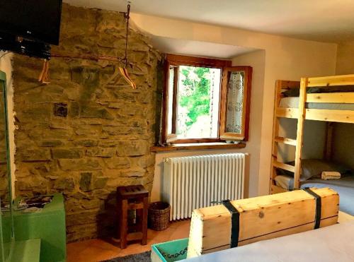 a room with a stone wall and a window at B&B La Presa in Molino del Pallone