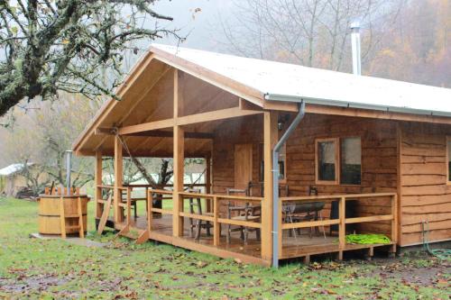 a log cabin with a porch and a deck at Karkú Lodge in Pucón