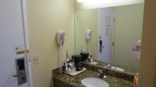 a bathroom with a counter with a sink and a phone at Baymont Inn & Suites by Wyndham Holbrook in Holbrook