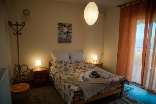 a bedroom with a dog laying on a bed at Paradise View Apartment in Paleo Tsifliki