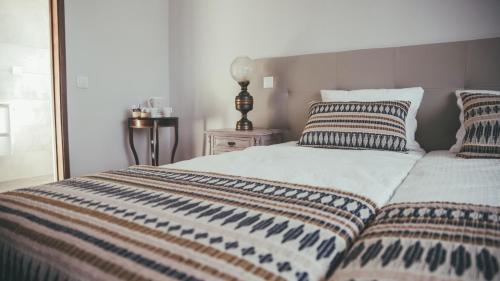 a bed with two pillows on it in a bedroom at Vila Milreu Guest House in Estói