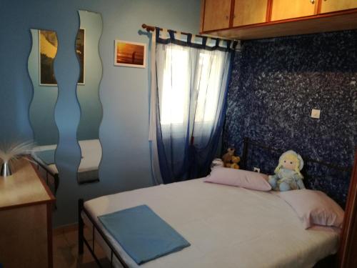 a bedroom with a bed with two teddy bears on it at Relaxing Beautiful Holiday Home in Lávrion