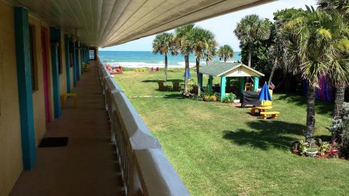 a view of the beach from the balcony of a house at South Beach Inn - Cocoa Beach in Cocoa Beach
