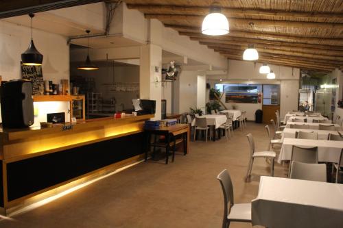 a dining room with tables and chairs and a counter at Hotel Miramar in Huarmey