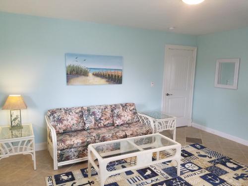 a living room with a couch and a table at Pierhouse Bed & Breakfast in Kill Devil Hills