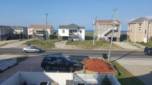 a car parked in a parking lot in front of houses at Pierhouse Bed & Breakfast in Kill Devil Hills