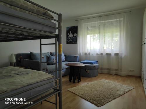 a bedroom with a bunk bed and a table at Ferienwohnung Allgäuglück in Waltenhofen