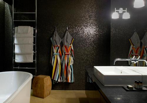 a bathroom with a sink and a tub and towels at Port Phillip Estate in Red Hill South