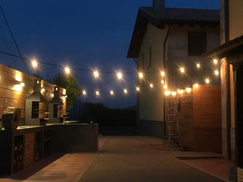 a string of lights on a house at night at Las Casitas de Santillana in Santillana del Mar