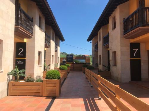 a walkway between two buildings with numbers on them at Las Casitas de Santillana in Santillana del Mar