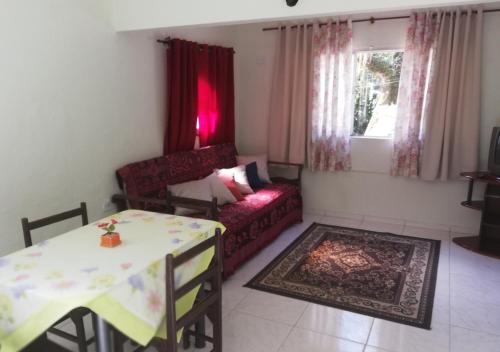 a living room with a couch and a table at Pousada Bem Querer in Penedo