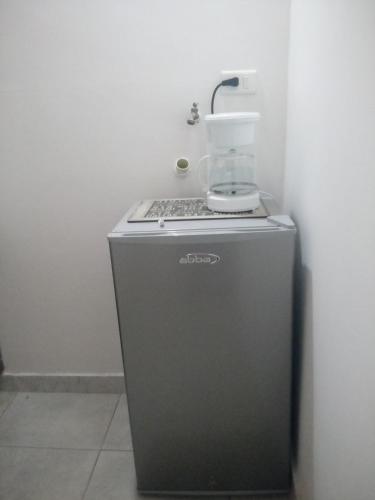 a blender sitting on top of a small refrigerator at El Hogar de Ami in Cali