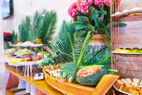 a buffet of food with vegetables and fruits on display at Boss Hotel in Nha Trang