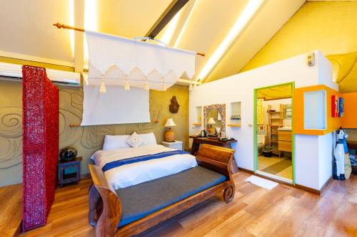 a bedroom with a large bed and a mirror at Pancala Vacation Inn in Nanwan