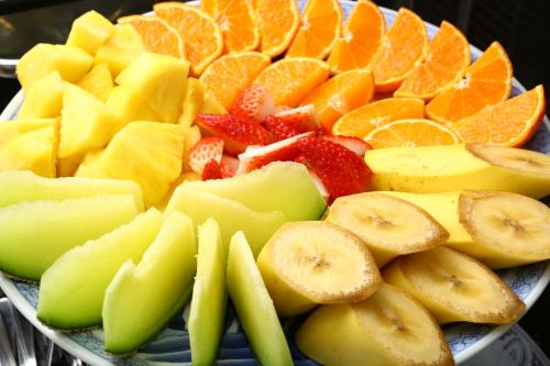 a plate full of fruit on a table at Chino Sky View Hotel in Chino