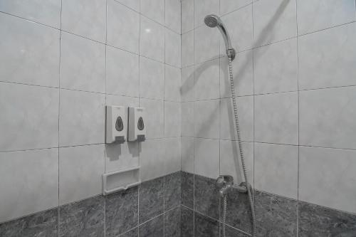 a shower in a bathroom with a shower at RedDoorz at Amellia Pasteur Bandung in Bandung