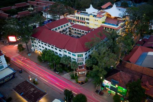 a building with a red roof on a city street at Baitong Heritage Hotel in Siem Reap