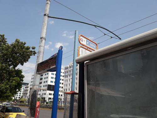 a bus stop with a sign in front of a building at Socrates path in Athens