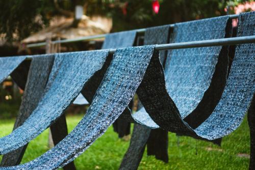 a bench with a blue towel hanging on it at Ock Pop Tok Mekong Villa in Luang Prabang