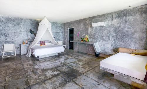 a bedroom with two beds and a tent in it at Villa Tao in Tabanan