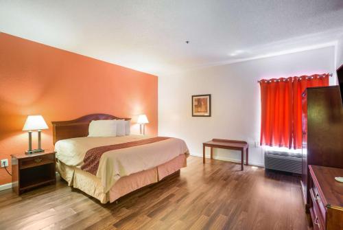 a hotel room with a bed and a television at Budgetel Inns & Suites - Atlanta Galleria Stadium in Atlanta