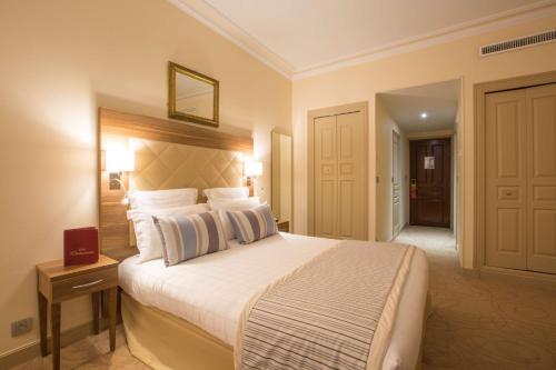 a bedroom with a large bed in a hotel room at Westminster Hotel & Spa Nice in Nice